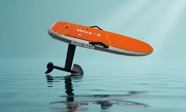 Rush Wave EFOIL EPP Y1 shown as an orange board hovering above calm water on a black hydrofoil mast and wings.