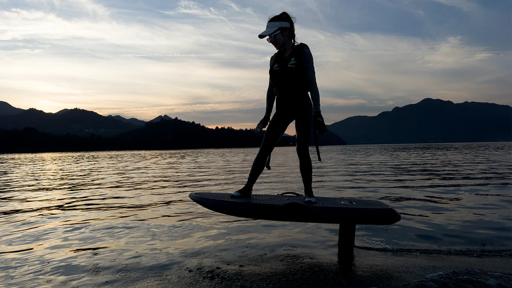 Rush Wave EFOIL EPP Y1, rider silhouetted above mountain lake