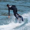 Rush Wave RD12 electric surfboard in action Rider carving on the white and black Rush Wave RD12 electric surfboard