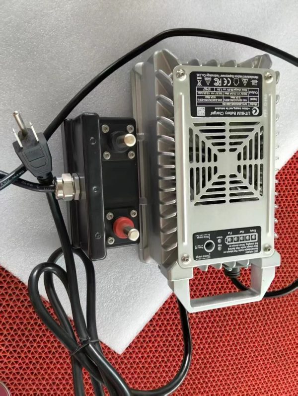 Rush Wave Dedicated Surfboard Charger, 58.8 V IP67 unit Rush Wave dedicated surfboard charger, a silver IP67 unit labeled 58.8 V with a black connector box.